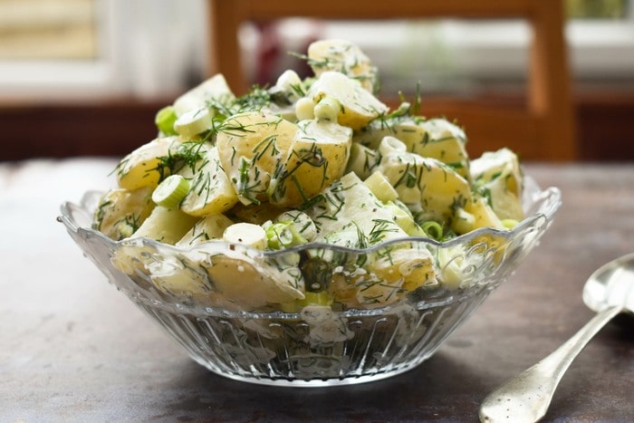 Dill potato salad in a clear glass bowl