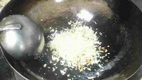 Cooking cabbage and carrot in a wok for lemon coriander soup