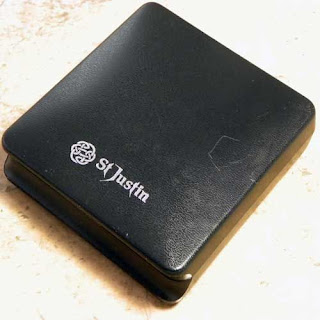 St Justin box with logo