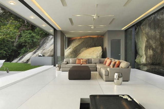 Photo of the living room with white floor and white ceiling along with the glass walls