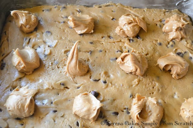 Peanut Butter Filling dropped on top of Blondies in a pan.