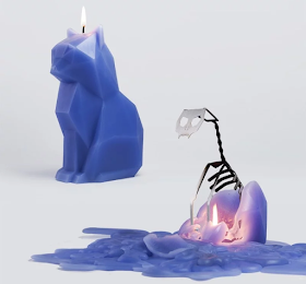 a purple candle in the shape of a cat