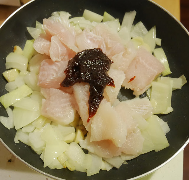 garlic, oinions, fish, and sweet chili paste in a frying pan