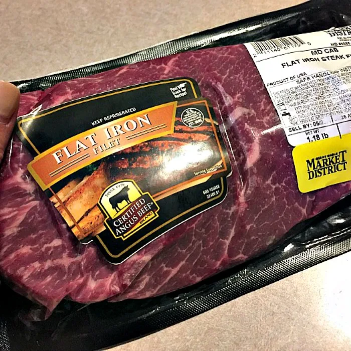 Uncooked, Certified Angus Beef (r) brand Flat Iron Steak in packaging