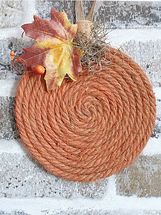 orange jute pumpkin with leaves and stem