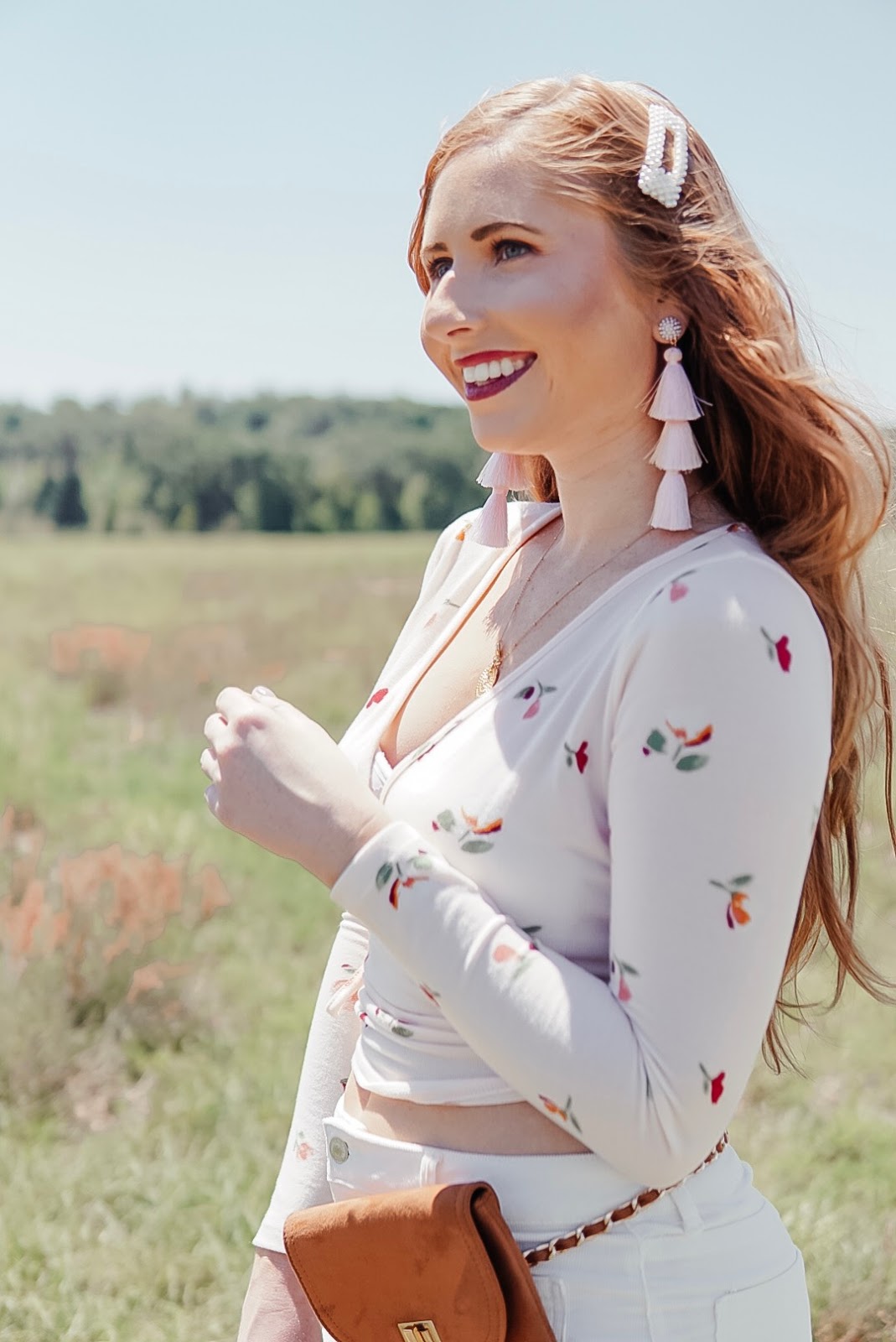 how to style 70s trends for spring wearing a floral print wrap top from forever 21 and white corduroy pants from forever 21