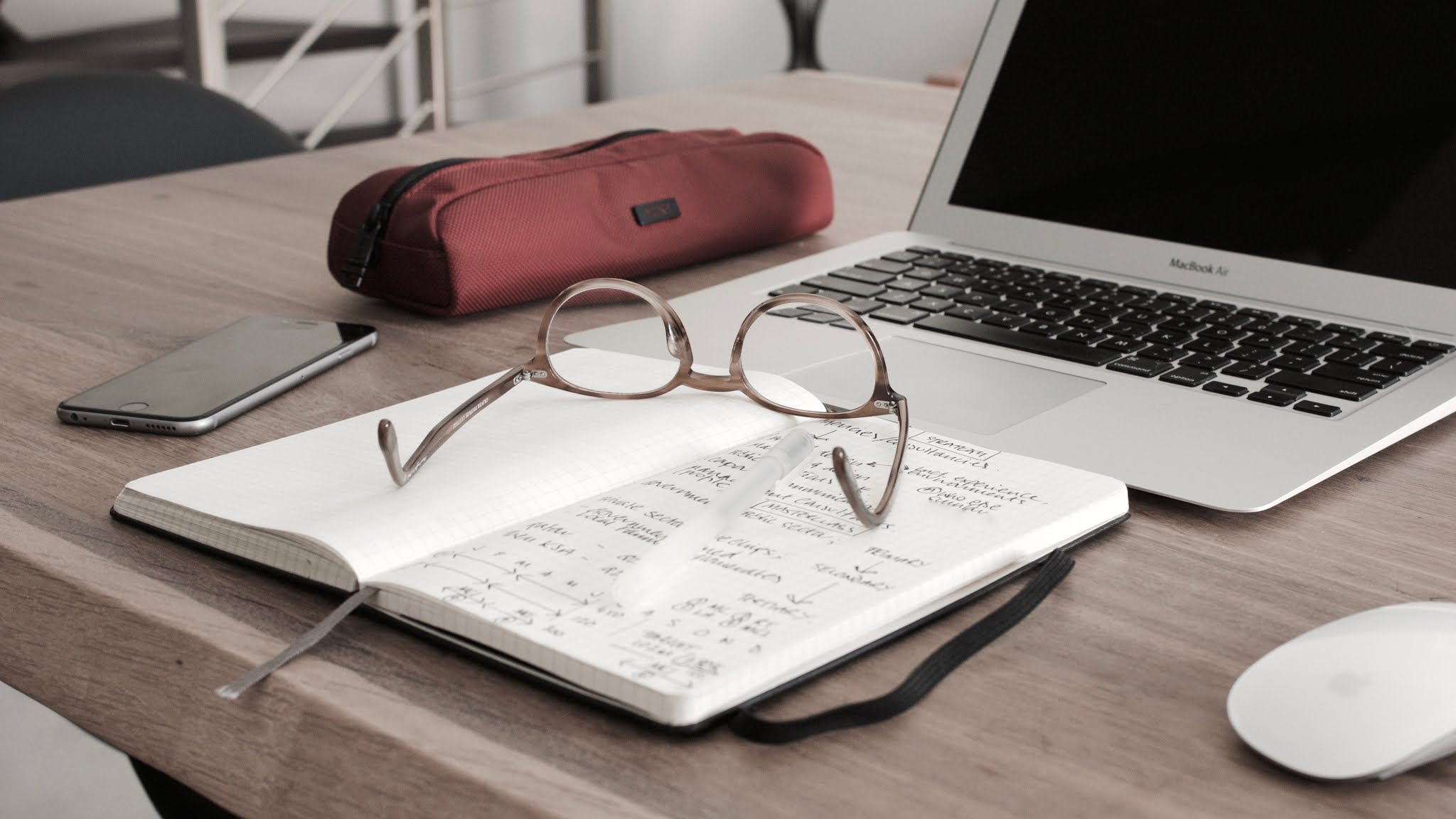 glasses on book beside laptop, studying at uk university first year student