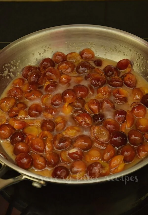 a pan with fresh pitted cherries cooking