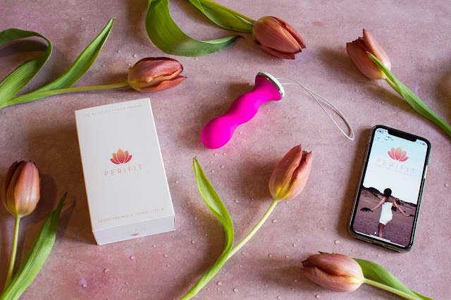 A flat lay showing the Perifit pelvic floor training device, the packaging and the an iphone Xs with the app on