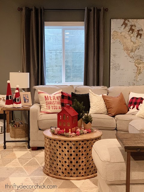 Red, white and black Christmas pillows on sofa