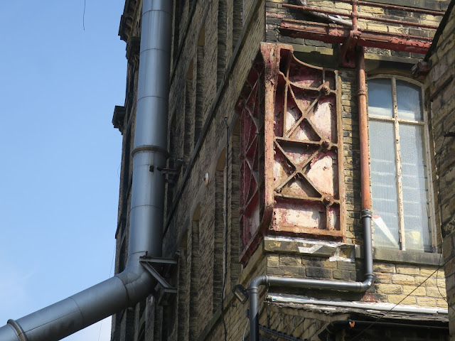 Old Building with pipes, window and metalwork. Sowerby Bridge. April 2021