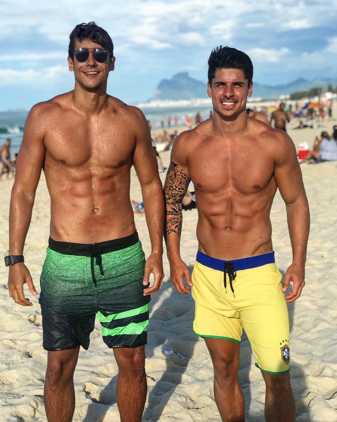 two-fit-shirtless-young-colombian-guys-smiling-beach-abs-hunks