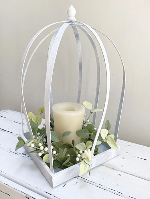 White lantern with wreath and candle