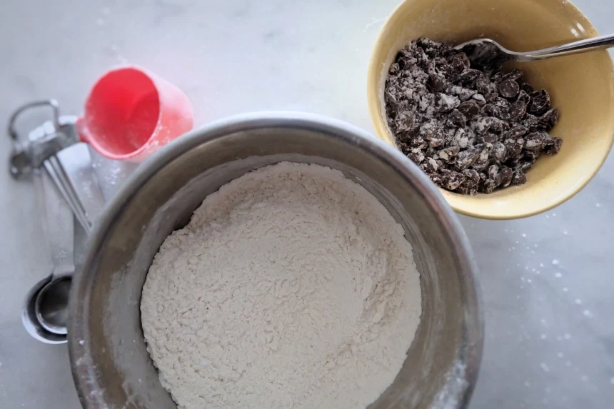 mixing some flour with chocolate chips