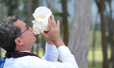 Hawaiian wedding minister blowing the conch shell