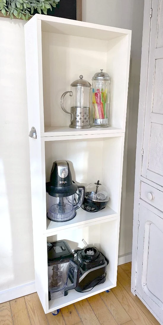 Stacked crate storage filled with small appliances.