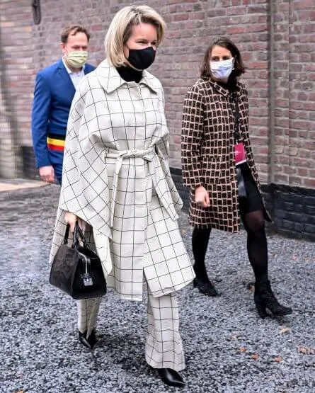 Queen Mathilde wore a new nevil check wool canvas cape and trousers from Natan. The Queen's new outfit is from the fashion house Natan