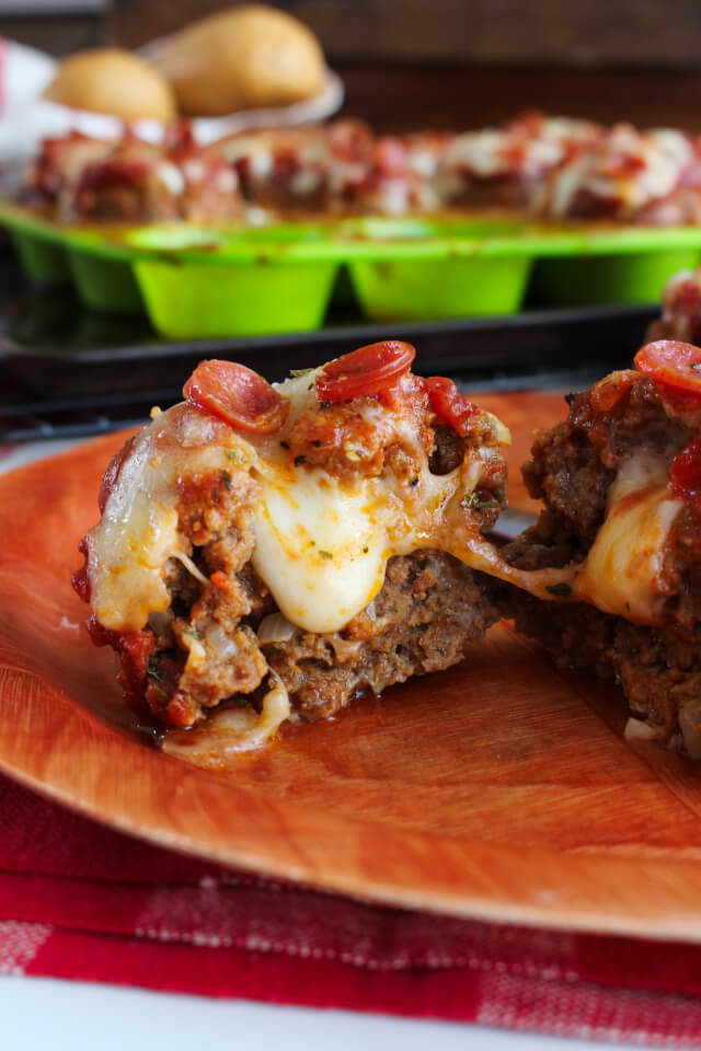 Mozzarella Stuffed Pizza Meatloaf Muffins are a pizza-fied twist on my family's favorite meatloaf muffin recipe, complete with cheesy stuffed centers, cute mini pepperonis, and RAGÚ®  Homestyle Sauce.  They will be a hit with your whole family will love! #SimmeredinTradition #Ragu #ad @RaguSauce