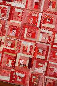 Wonky log cabin quilt in all red - there's a tutorial to make these blocks!