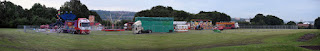 A panoramic photo showing the setting up of the funfair on Harbottle Park