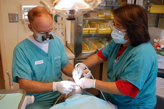 Two dentists examining a patient's dental health for All On 4 Dental Implants