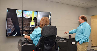 Image: shows a Student and Instructor using the hands-on Construction Technology equipment