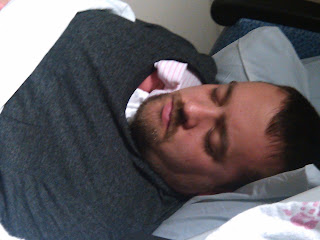 man with newborn twin snuggled together