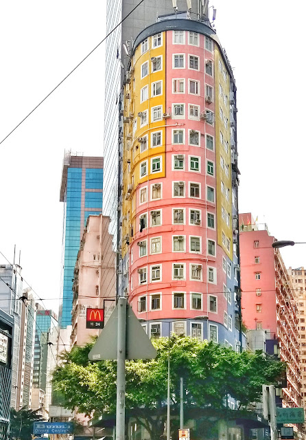 vertical living pastel colored vertical buildings in hong kong