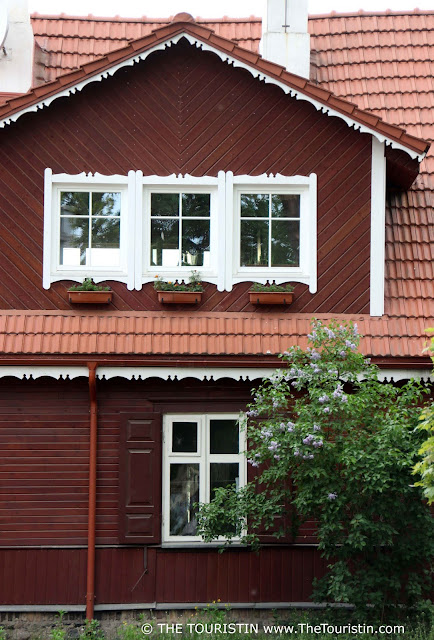 The facade of a red wooden house in Užupis in Lithuania.