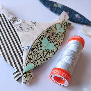 epp shapes and a spool of aurifil thread
