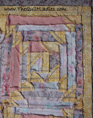 Pink Log cabin quilt with triangle corners