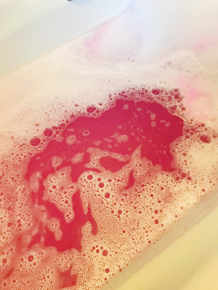 Dark pink water in bath from Lush Snow Fairy bath bomb