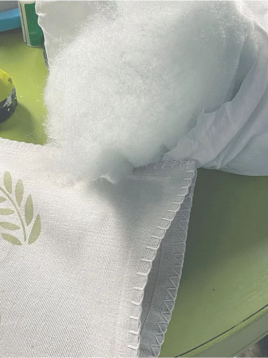 filling a pillow with Polyfil.