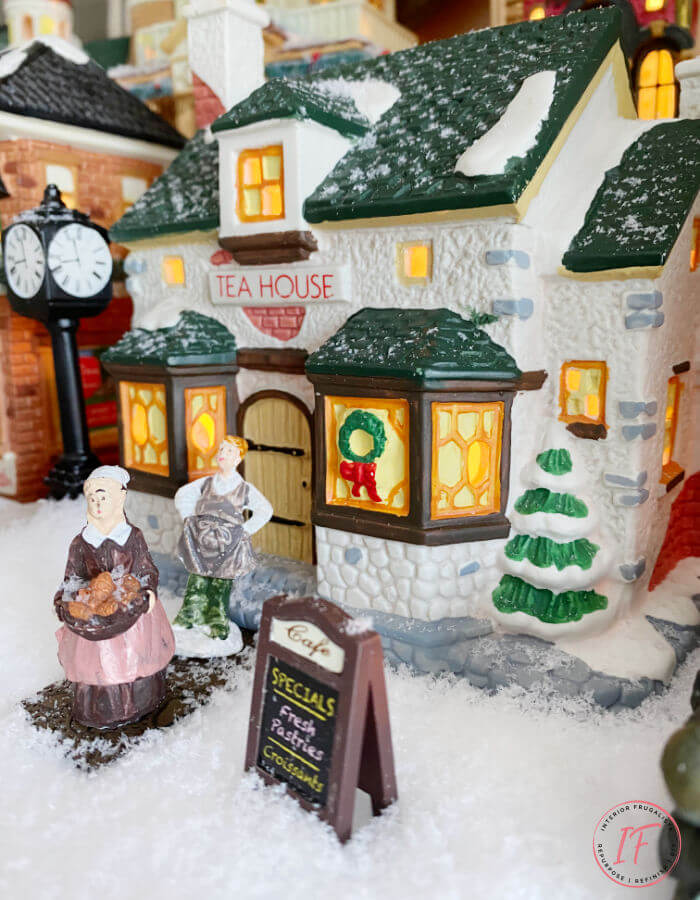 A nostalgic Victorian Christmas Village display on a fireplace mantle. A two level miniature Christmas scene with sentimental value.