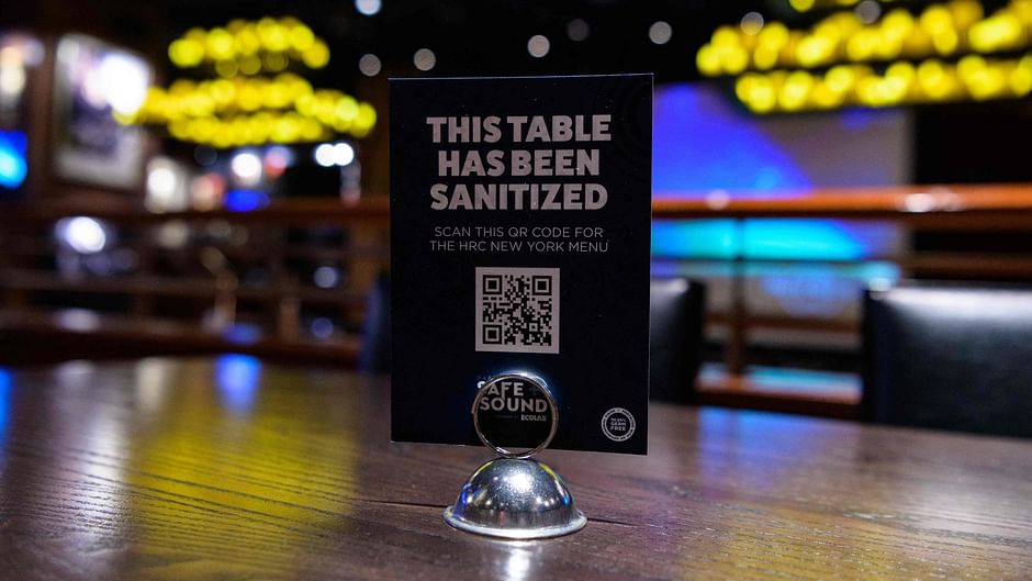 In this file photo a sign reading "This table has been sanitized" is displayed on a table at the Hard Rock Cafe on 3 May 2021 in New York City. AFP