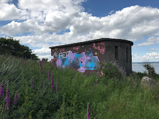 Bunker at north side of Cramond Island, Edinburgh.  The outside of the wall of the bunker is colourful with graffiti. Photo by Kevin Nosferatu for the Skulferatu Project