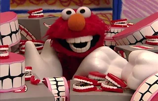 When Elmo opens the door of the room, a lot of chattering teeth fall on him. Sesame Street Elmo's World Teeth