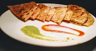 Aloo paratha cut into pieces and serve with mint Chutney and tomato ketchup