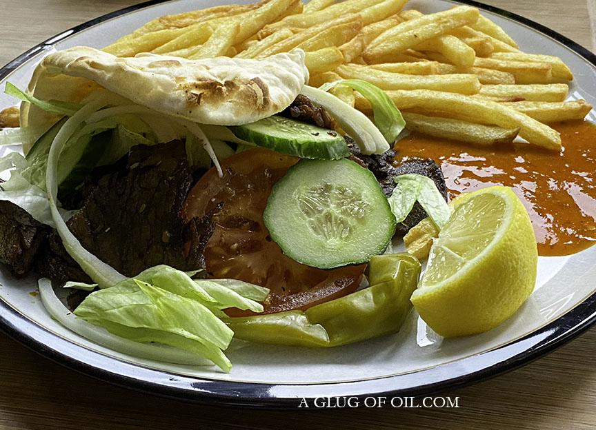 Homemade doner kebab with salad in pitta bread with fries.