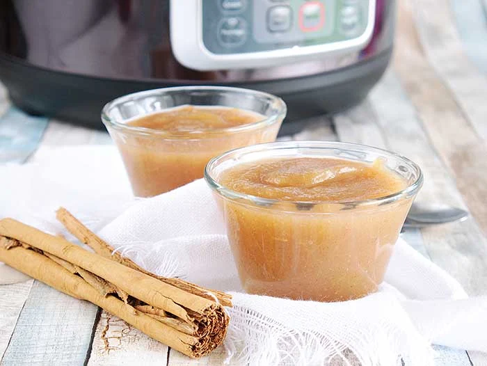How to make applesauce in an Instant Pot. Use your Instapot to make homemade healthy applesauce with honey and cinnamon. This whole 30 no sugar recipe makes unsweetened applesauce or honey sweetened applesauce, your choice.  Make quick small batch apple sauce for baby or for adults.  You can then make canned applesauce or put it in the freezer to save for later. Freezing recipes is easier ofr his DIY home made recipes. Also gives tips for the best apples to use.  #instantpot #applesauce #apples