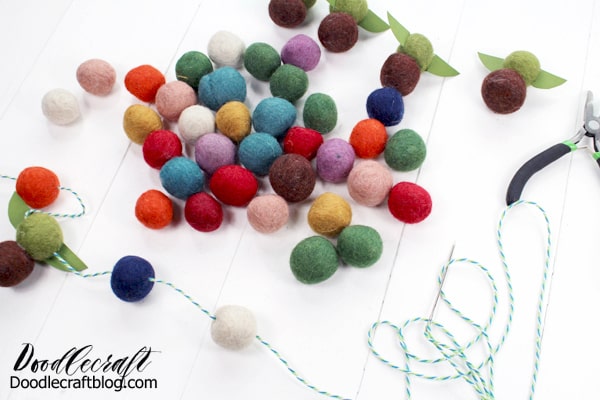 String the bakers twine through the felt balls and baby Yoda's to make a garland.