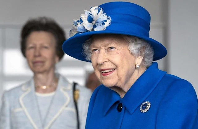 The Queen wore a royal blue velour coat by Stewart Parvin, a matching silk dress. Prince Albert's Sapphire brooch