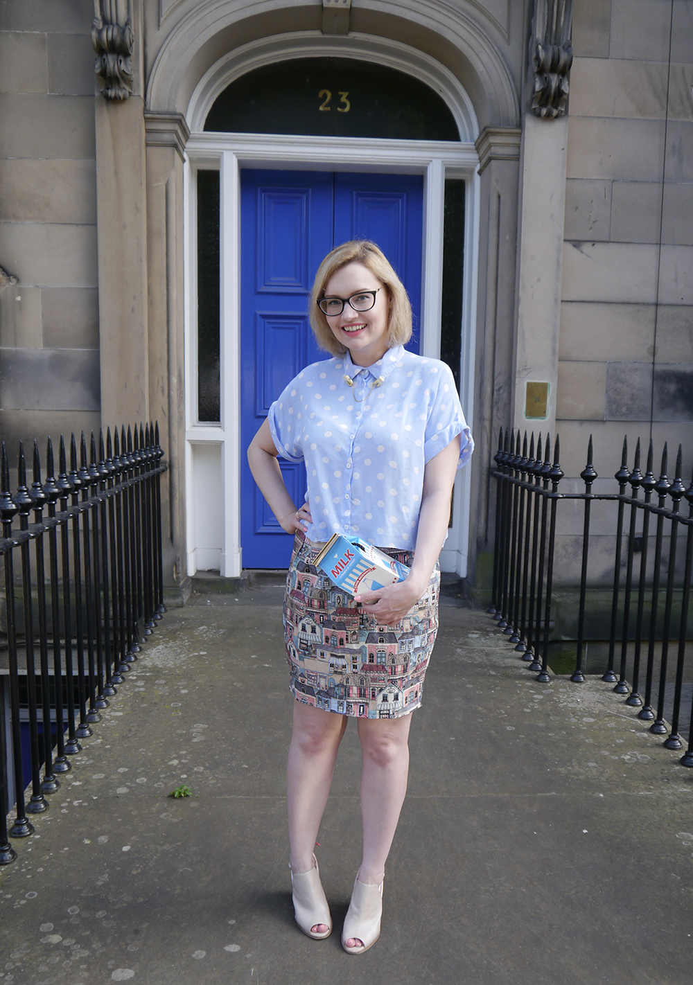 Scottish blogger Kimberley from Wardrobe Conversations in quirky milk theme outfit in Edinburgh Scottish blogger, Edinburgh blogger, polkadot shirt, teeth collar clips, novelty milky bag, blue door edinburgh, Scottish street style, quirky street style, dressing to a theme, food inspired outfit, pale girl style,
