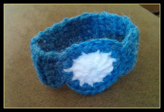 Pictured is the completed project - a blue and white crocheted watch for pretend play for a toddler.
