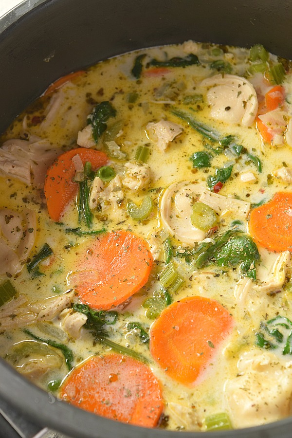 a black pan with creamy chicken tortellini soup