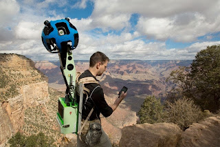 Google pic of a man with camera on his back in the Grand Canyon