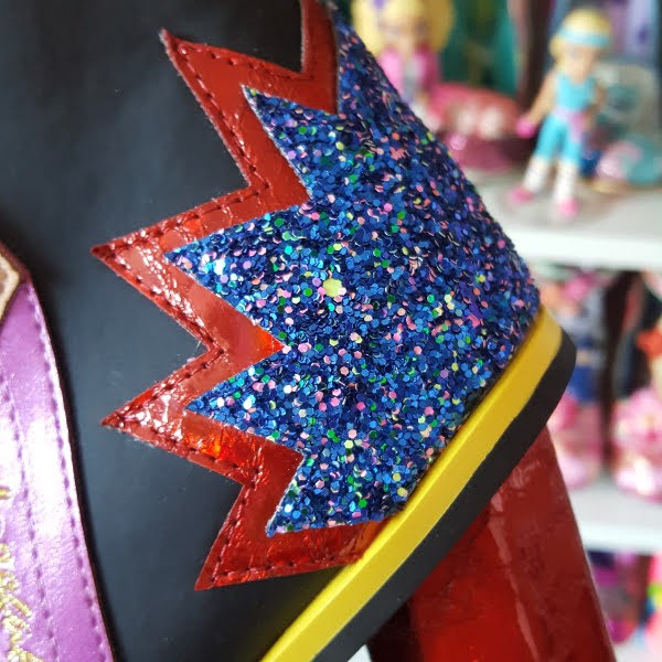 close up of bright blue and red metallic glitter section at heel of boot