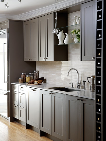 Dark painted cabinets in kitchen with open glass shelving by Sarah Richardson