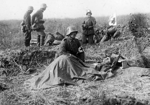 Walter was just 16 when he fought at the Somme but his photos soon took on dark tone. Here he captures a German army medic kneeling beside a dying colleague - but he can do no more than offer comfort.