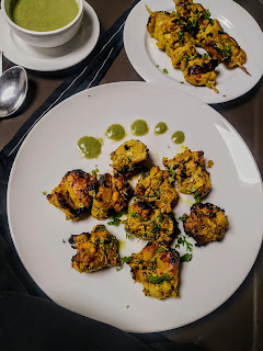 Serving banjara kebab in a plate, banjara kebab in sticks in background